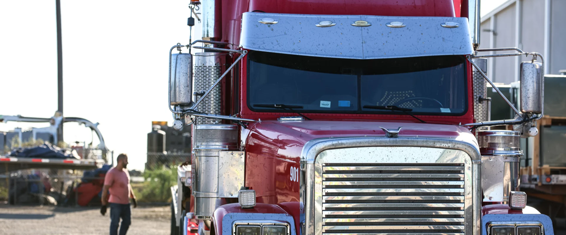 Close-up front view of a red Freightliner Classic tractor truck