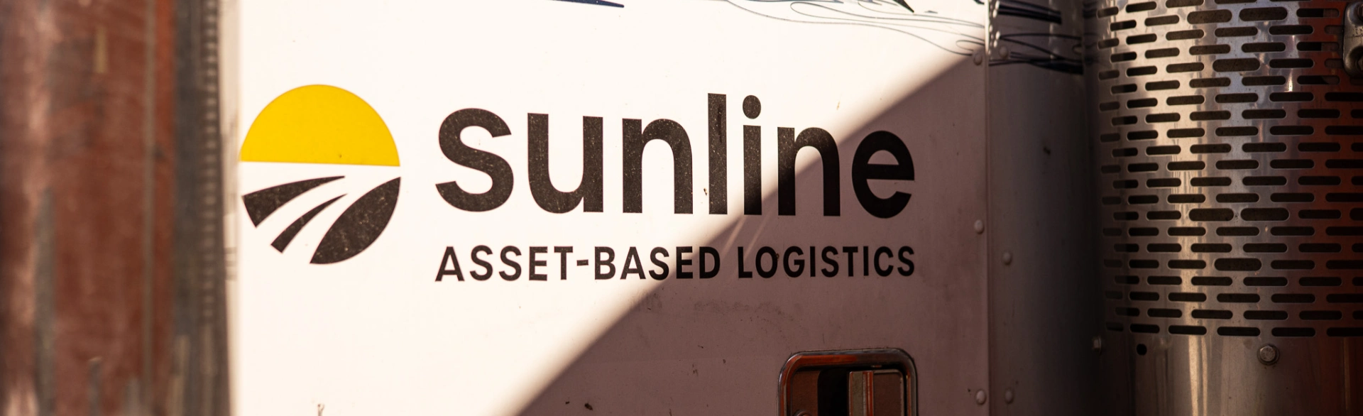 Close-up of Sunline Logo on the door of a white tractor truck