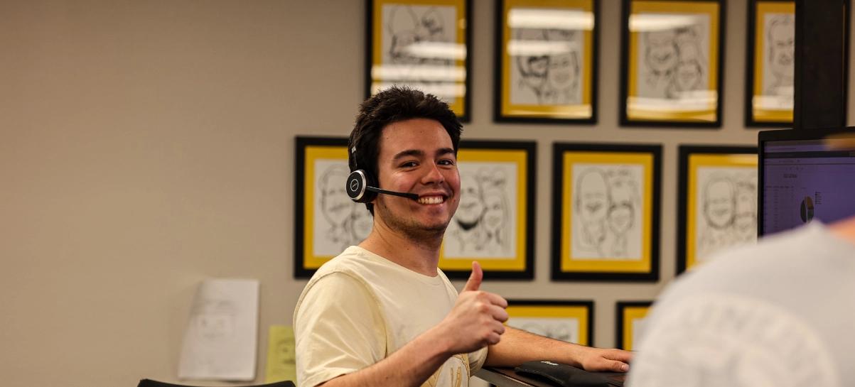 Male Sunline dispatcher wearing a headset giving a thumbs up